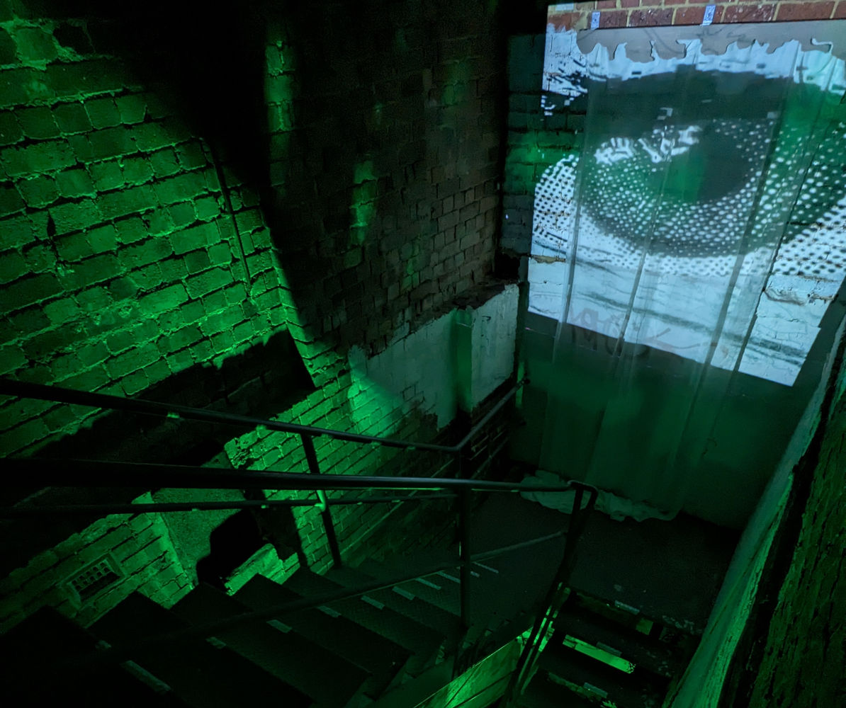 One view of the installation project 'Abnormal: An intermission', shades of green and an eye dominate.